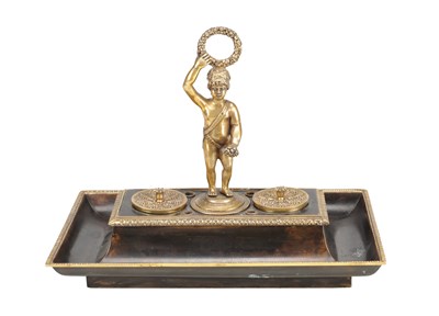 Lot 982 - A FRENCH ORMOLU AND LACQUERED METAL DESK TIDY WITH TWIN INK POTS AND PUTTO FINIAL