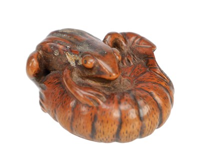 Lot 533 - A JAPANESE BOXWOOD NETSUKE OF A FROG ON A PUMPKIN