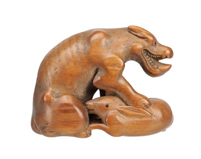 Lot 540 - A MEIJI PERIOD JAPANESE BOXWOOD NETSUKE AS A DOG CATCHING A RABBIT