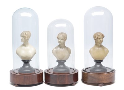 Lot 903 - A COLLECTION OF THREE WAXWORK BUSTS OF YOUNG LADIES UNDER GLASS DOMES ON MAHOGANY BASES