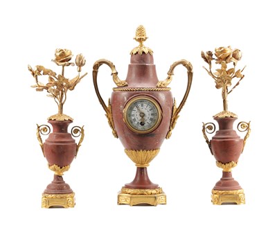 Lot 1281 - A LATE 19TH CENTURY ROUGE MARBLE AND ORMOLU MOUNTED THREE PIECE CLOCK GARNITURE