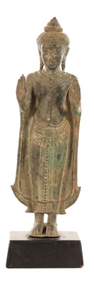 Lot 456 - A SOUTHEAST ASIAN BRONZE STANDING BUDDHA ON WOOD STAND