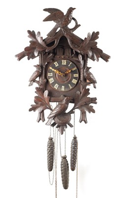Lot 1269 - AN EARLY 20TH CENTURY BLACK FOREST CARVED LINDEN WOOD THREE WEIGHT CUCKOO/QUAIL WALL CLOCK