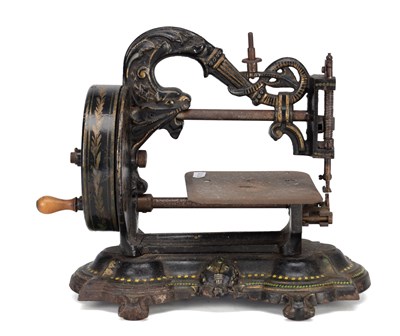 Lot 1080 - A LATE 19TH CENTURY CAST IRON HAND-CRANK SEWING MACHINE