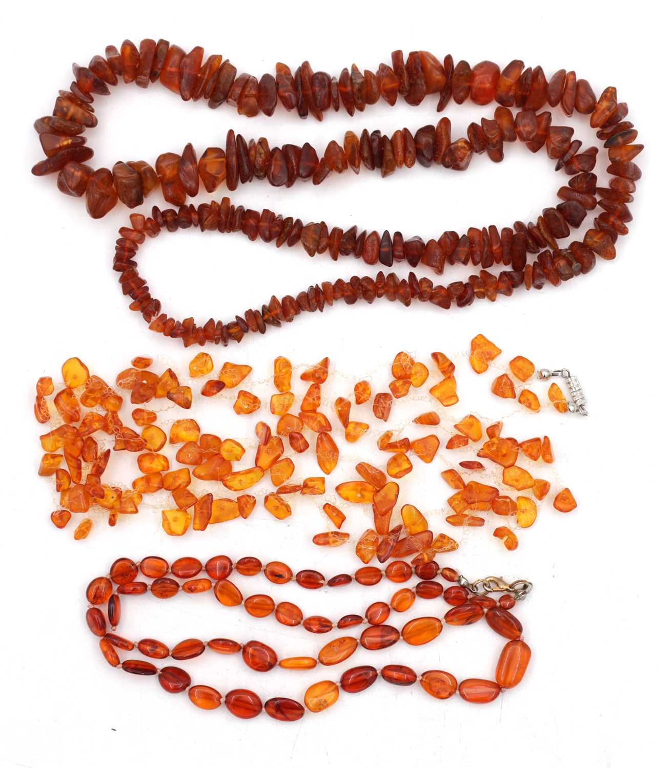 Lot 222 - A COLLECTION OF THREE AMBER NECKLACES