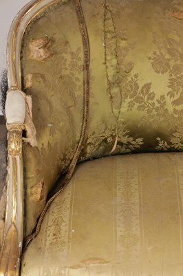 Lot 1584 - A GEORGE III PARCEL GILT AND PAINTED HEPPLEWHITE STYLE THREE SEATER SETTEE