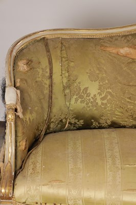 Lot 1584 - A GEORGE III PARCEL GILT AND PAINTED HEPPLEWHITE STYLE THREE SEATER SETTEE