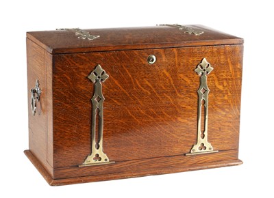 Lot 1370 - AN ARTS AND CRAFTS OAK WRITING BOX WITH PIERCED BRASS MOUNTS