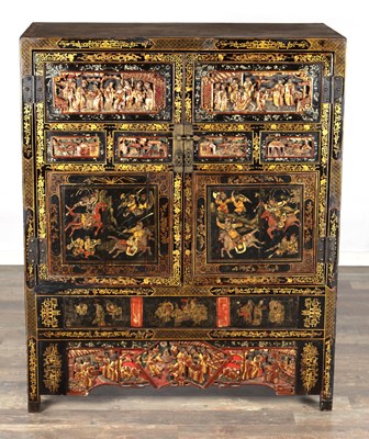 Lot 1487 - A LATE 19TH CENTURY CHINESE INLAID BLACK LACQUER CABINET WITH RELIEF CARVED GILT PANELS