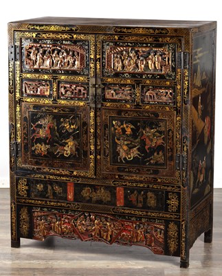 Lot 1487 - A LATE 19TH CENTURY CHINESE INLAID BLACK LACQUER CABINET WITH RELIEF CARVED GILT PANELS
