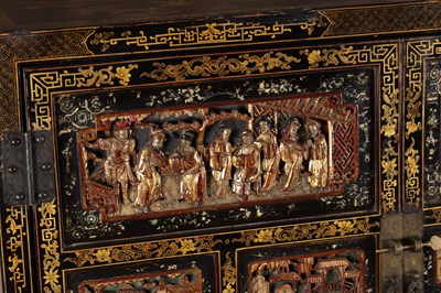Lot 1487 - A LATE 19TH CENTURY CHINESE INLAID BLACK LACQUER CABINET WITH RELIEF CARVED GILT PANELS
