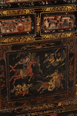 Lot 1487 - A LATE 19TH CENTURY CHINESE INLAID BLACK LACQUER CABINET WITH RELIEF CARVED GILT PANELS