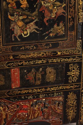 Lot 1487 - A LATE 19TH CENTURY CHINESE INLAID BLACK LACQUER CABINET WITH RELIEF CARVED GILT PANELS