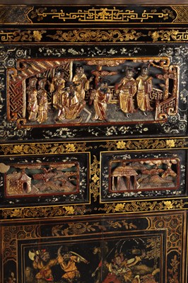 Lot 1487 - A LATE 19TH CENTURY CHINESE INLAID BLACK LACQUER CABINET WITH RELIEF CARVED GILT PANELS