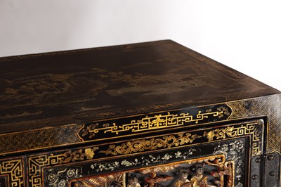 Lot 1487 - A LATE 19TH CENTURY CHINESE INLAID BLACK LACQUER CABINET WITH RELIEF CARVED GILT PANELS