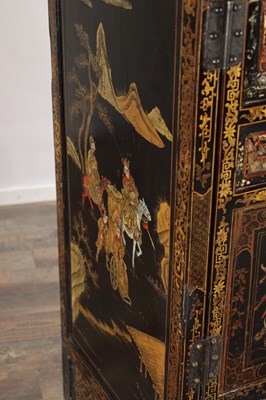 Lot 1487 - A LATE 19TH CENTURY CHINESE INLAID BLACK LACQUER CABINET WITH RELIEF CARVED GILT PANELS