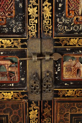 Lot 1487 - A LATE 19TH CENTURY CHINESE INLAID BLACK LACQUER CABINET WITH RELIEF CARVED GILT PANELS