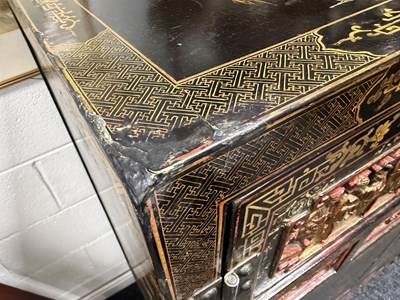 Lot 1487 - A LATE 19TH CENTURY CHINESE INLAID BLACK LACQUER CABINET WITH RELIEF CARVED GILT PANELS