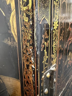 Lot 1487 - A LATE 19TH CENTURY CHINESE INLAID BLACK LACQUER CABINET WITH RELIEF CARVED GILT PANELS