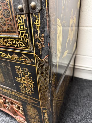Lot 1487 - A LATE 19TH CENTURY CHINESE INLAID BLACK LACQUER CABINET WITH RELIEF CARVED GILT PANELS