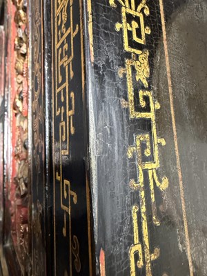 Lot 1487 - A LATE 19TH CENTURY CHINESE INLAID BLACK LACQUER CABINET WITH RELIEF CARVED GILT PANELS
