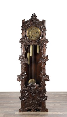 Lot 1354 - AN EARLY 20TH CENTURY BLACK FOREST CARVED WALNUT LONGCASE CLOCK
