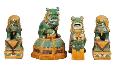 Lot 725 - A COLLECTION OF FOUR EARLY 20TH CENTURY CHINESE POLYCHROME GLAZED EARTHENWARE GUARDIAN LIONS