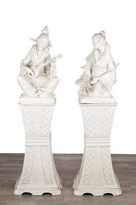 Lot 675 - A LARGE PAIR OF BLANC DE CHINE CHINESE STYLE PORCELAIN FIGURES ON PEDESTALS