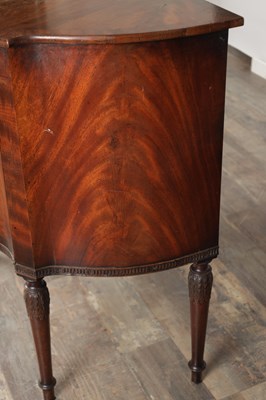 Lot 1602 - A GEORGE III MAHOGANY SERPENTINE SIDE CABINET
