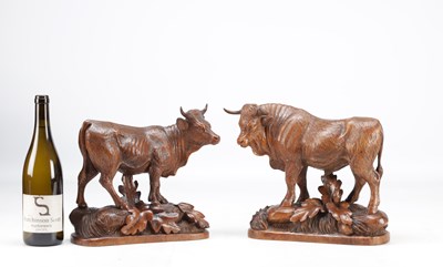 Lot 1427 - IN THE MANNER OF HUGGLER (SWISS 1834-1912) A PAIR OF 19TH CENTURY LINDEN WOOD BLACK FOREST COW AND BULL