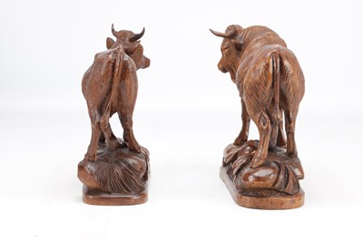 Lot 1427 - IN THE MANNER OF HUGGLER (SWISS 1834-1912) A PAIR OF 19TH CENTURY LINDEN WOOD BLACK FOREST COW AND BULL