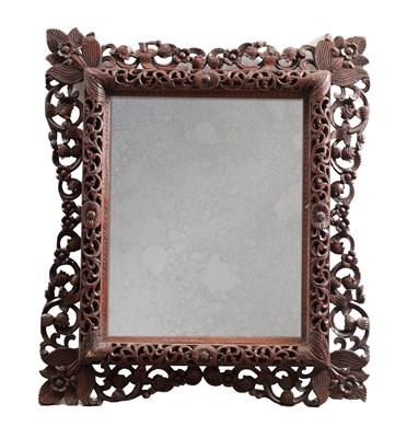 Lot 1547 - A CARVED HARDWOOD MIRROR