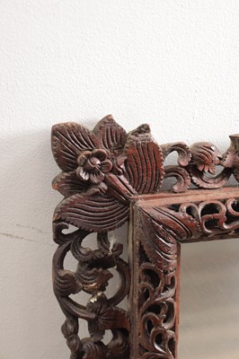 Lot 1547 - A CARVED HARDWOOD MIRROR
