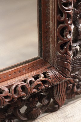 Lot 1547 - A CARVED HARDWOOD MIRROR