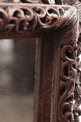 Lot 1547 - A CARVED HARDWOOD MIRROR