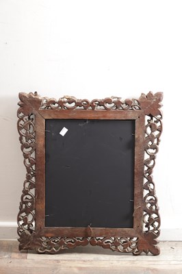 Lot 1547 - A CARVED HARDWOOD MIRROR