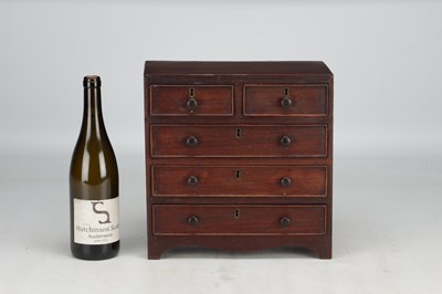 Lot 1597 - A 19TH CENTURY MAHOGANY MINIATURE CHEST OF DRAWERS