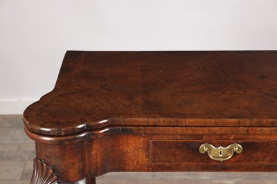 Lot 1689 - A QUEEN ANNE FIGURED WALNUT TEA TABLE