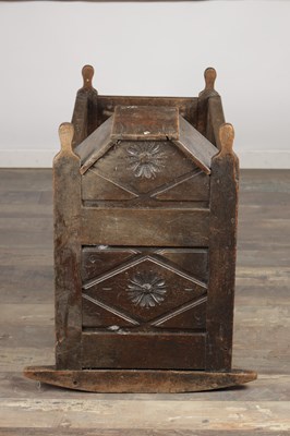 Lot 1527 - A 17TH CENTURY ENGLISH OAK HOODED ROCKING CRADLE