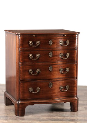 Lot 1515 - AN UNUSUAL GEORGE III STYLE MAHOGANY SERPENTINE CHEST OF DRAWERS WITH BRUSHING SLIDE