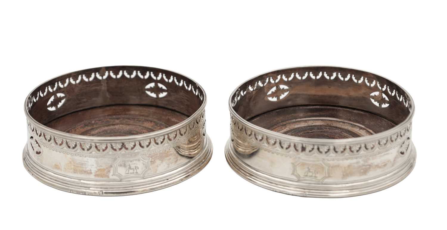 Lot 106 - A PAIR OF GEORGIAN ENGLISH SILVER BOTTLE COASTERS