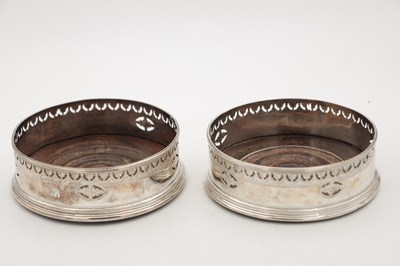 Lot 106 - A PAIR OF GEORGIAN ENGLISH SILVER BOTTLE COASTERS
