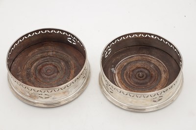 Lot 106 - A PAIR OF GEORGIAN ENGLISH SILVER BOTTLE COASTERS