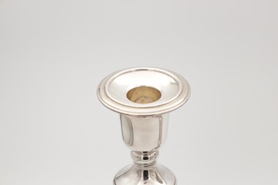 Lot 42 - A COLLECTION OF THREE EARLY 21ST CENTURY ENGLISH SILVER CANDLESTICKS BY CARRS
