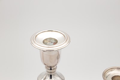 Lot 42 - A COLLECTION OF THREE EARLY 21ST CENTURY ENGLISH SILVER CANDLESTICKS BY CARRS