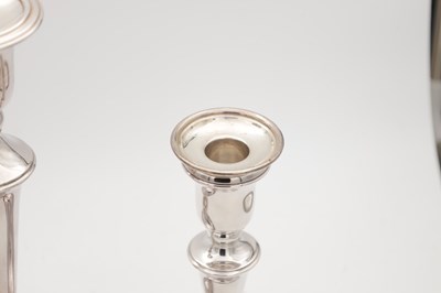 Lot 42 - A COLLECTION OF THREE EARLY 21ST CENTURY ENGLISH SILVER CANDLESTICKS BY CARRS