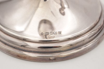 Lot 42 - A COLLECTION OF THREE EARLY 21ST CENTURY ENGLISH SILVER CANDLESTICKS BY CARRS