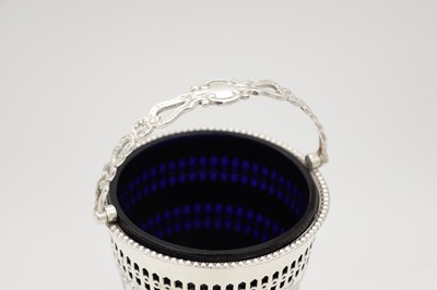 Lot 94 - A 19TH/20TH CENTURY SILVER SUGAR BASKET WITH BLUE GLASS LINER