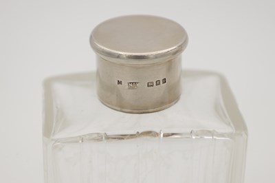 Lot 30 - A COLLECTION OF THREE GLASS SILVER-TOPPED BOTTLES