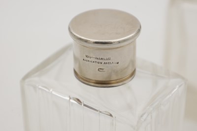 Lot 30 - A COLLECTION OF THREE GLASS SILVER-TOPPED BOTTLES